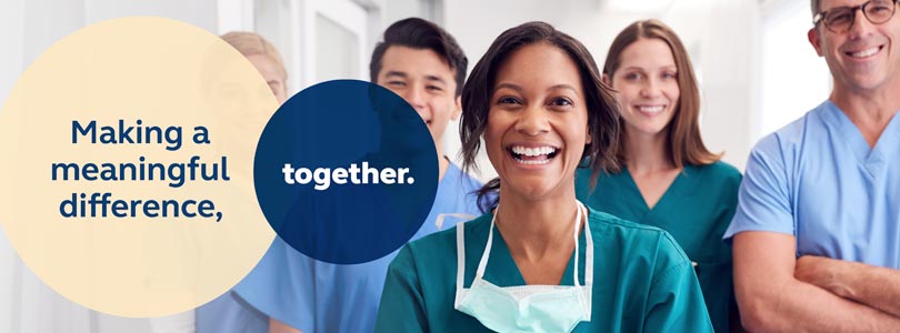 Hospital staff standing side by side smiling at camera, with the text &quot;Making a meaningful difference, together&quot; overlaying transparent circles
