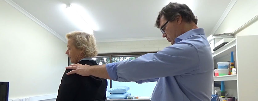 Pain specialist Dr Paul Frank examines a patients back at Buderim Private Hospital.